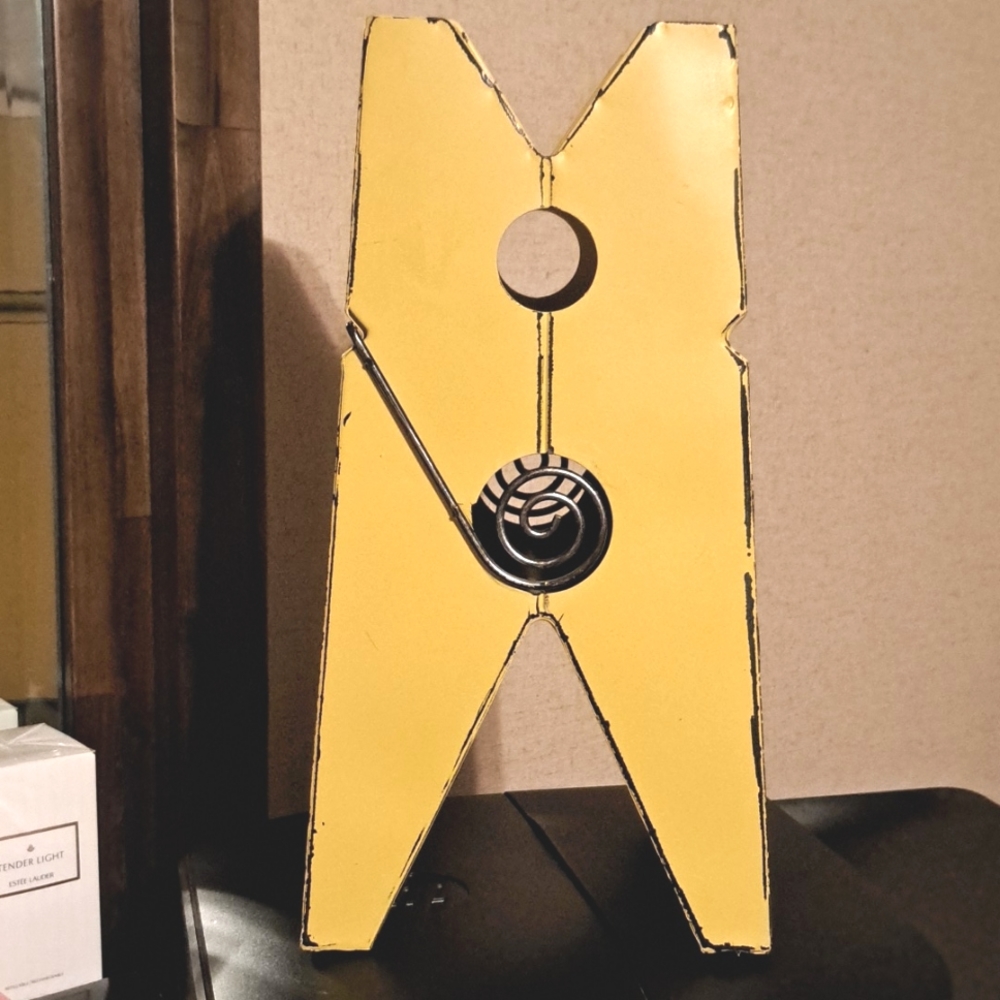 A giant sized rustic yellow clothes pin, decor